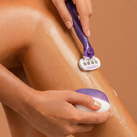 Woman using REMAY shaving cream bar on her leg with a razor showing a glossy translucent micro-barrier on a beige background