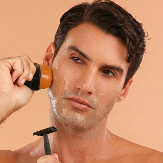 Man shaving his face with a razor and REMAY shaving cream against a beige background