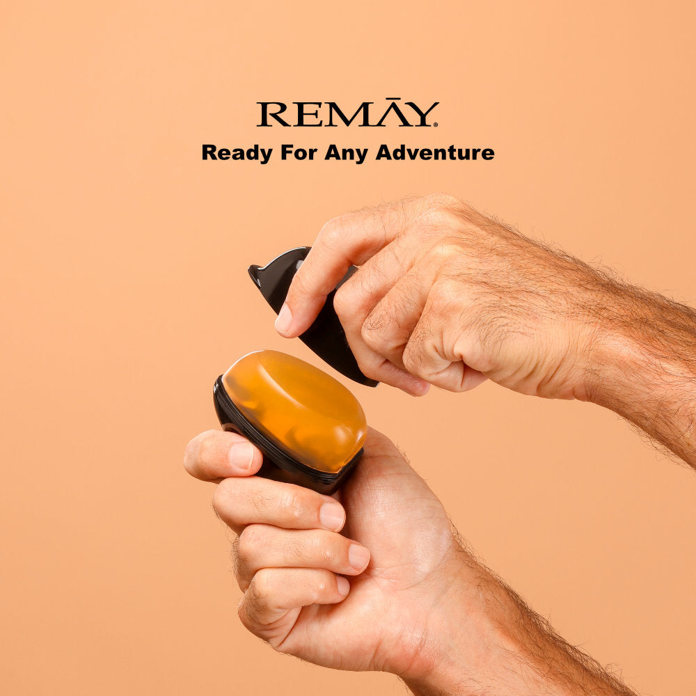 Mans hand holding a black and orange shaving gel with 'REMAY' branding on a beige background with ext that reads "Ready for any adventure"