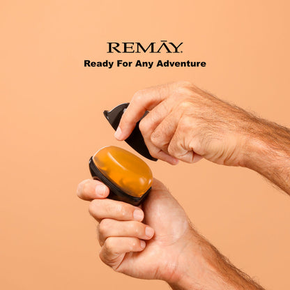 Mans hand holding a black and orange shaving gel with 'REMAY' branding on a beige background with ext that reads "Ready for any adventure"