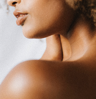 Close-up of a person's shoulder and neck with a blurred background.