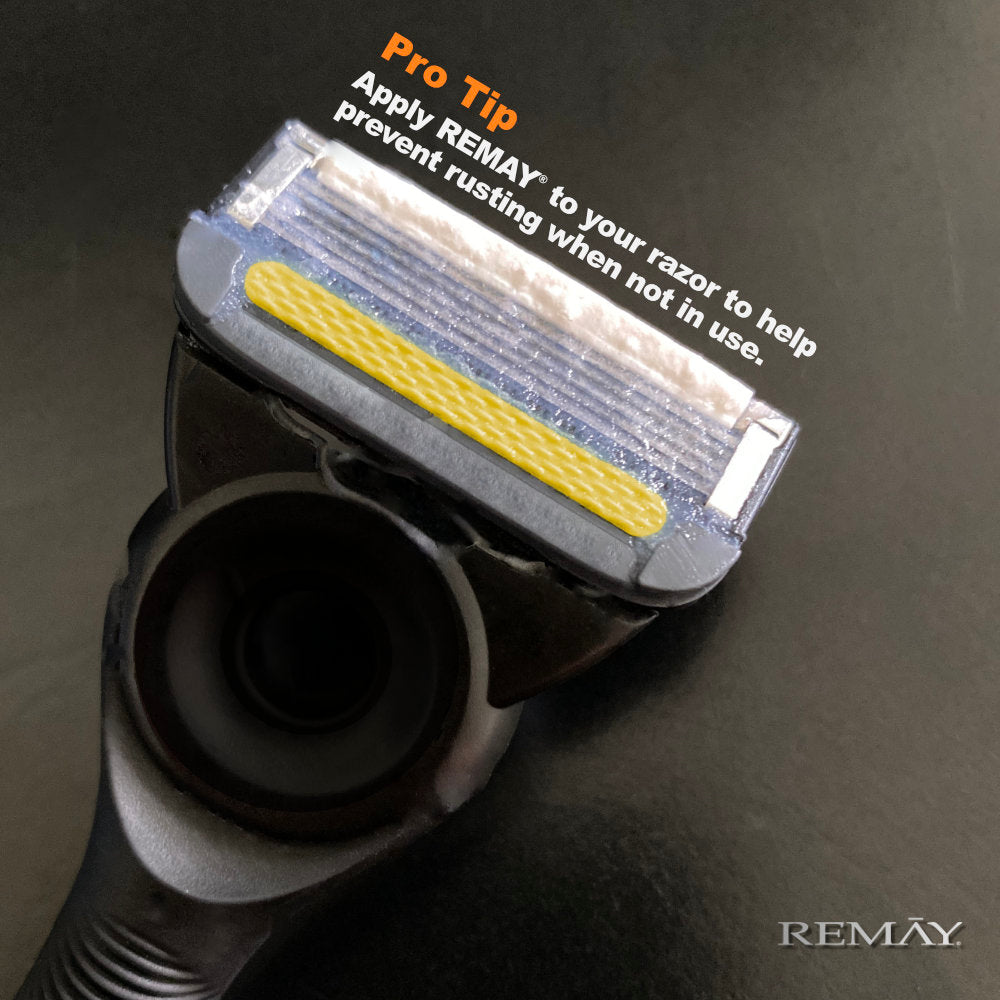 Cartridge razor on a dark background, featuring a pro tip about preventing rust with text that reads "Apply REMAY to your razor to help prevent rusting when not in use".